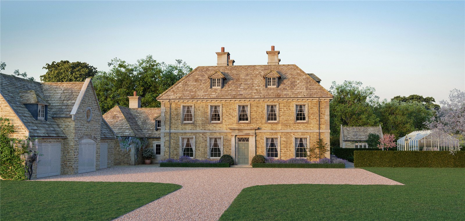 Cotswold country house framed by mature trees
